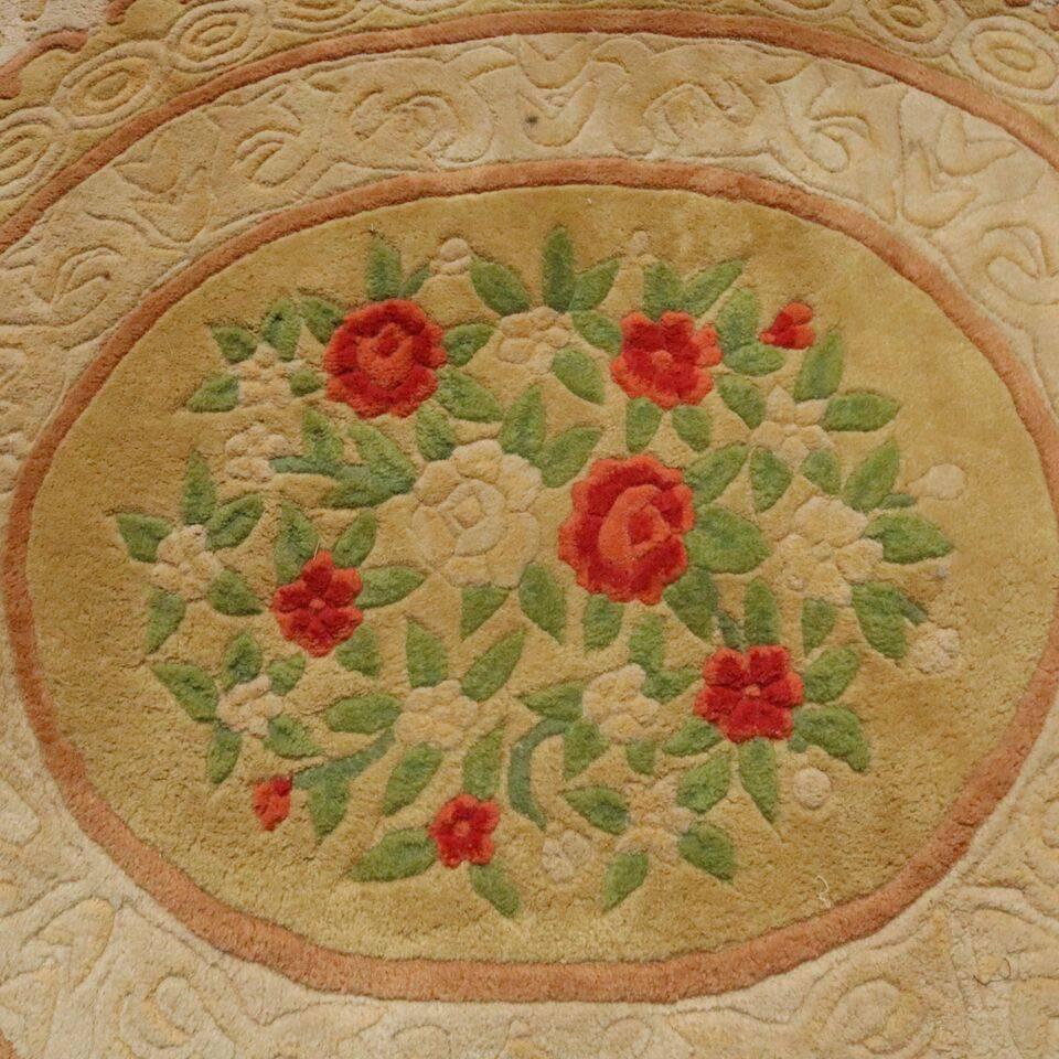 Oversized French Aubusson style pile carpet features border of flowers and bows and central medallion of roses flanked by urns on cream ground, approx 10' x 16', circa 1950.


Measures - 120