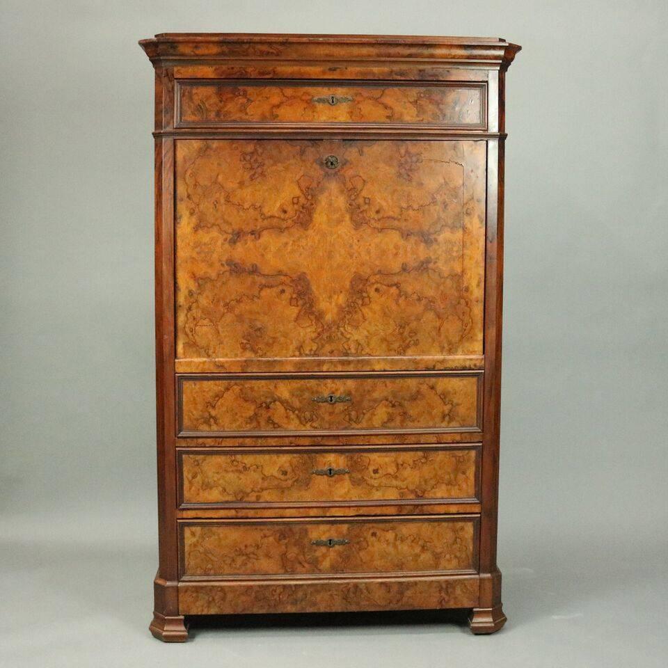 Antique Classical Empire Biedermeier abattant (drop front secretary) features bookmatched burled walnut with drop front opening to reveal writing surface and interior storage compartments including long and smaller drawers, pigeon holes and locking