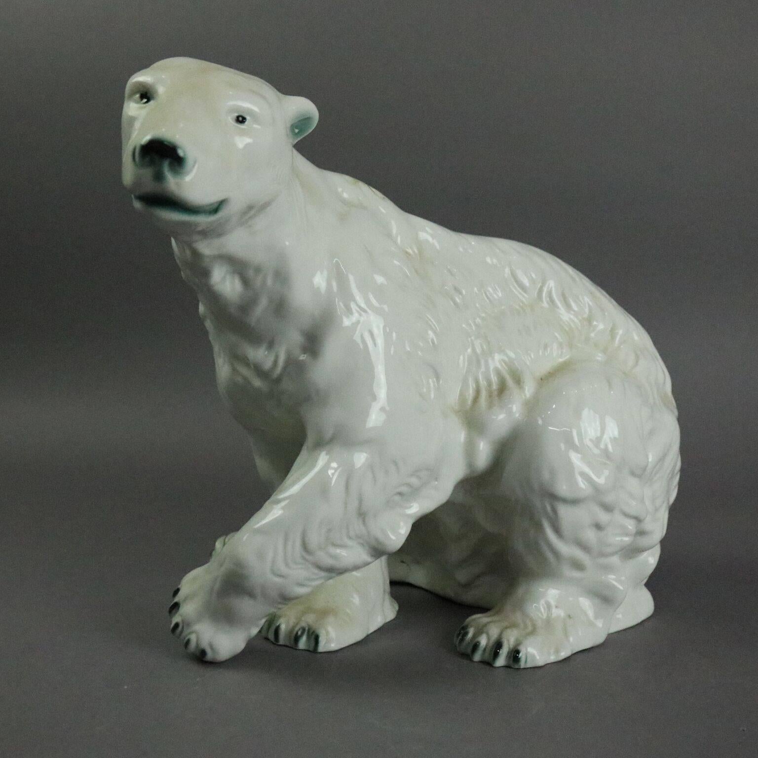 Large antique Czechoslovakia porcelain Royal Dux polar bear sculpture, signed with pink Royal Dux triangle on rear leg and green mark on base, circa 1900.

Measurements: 10.5" H x 14" W x 7" D.