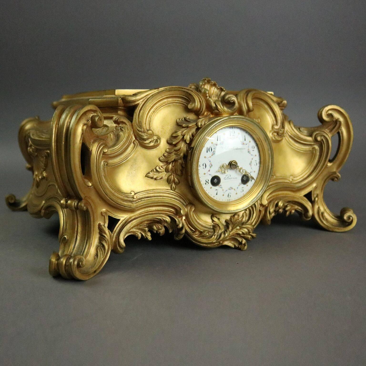 Antique French Barbedienne gilt bronze mantel clock features scrolled, foliate and scale decoration, hand-painted porcelain dial with floral swags with "Barbedienne" and "Marice", signed F. Barbedienne, circa 1870

Measures -