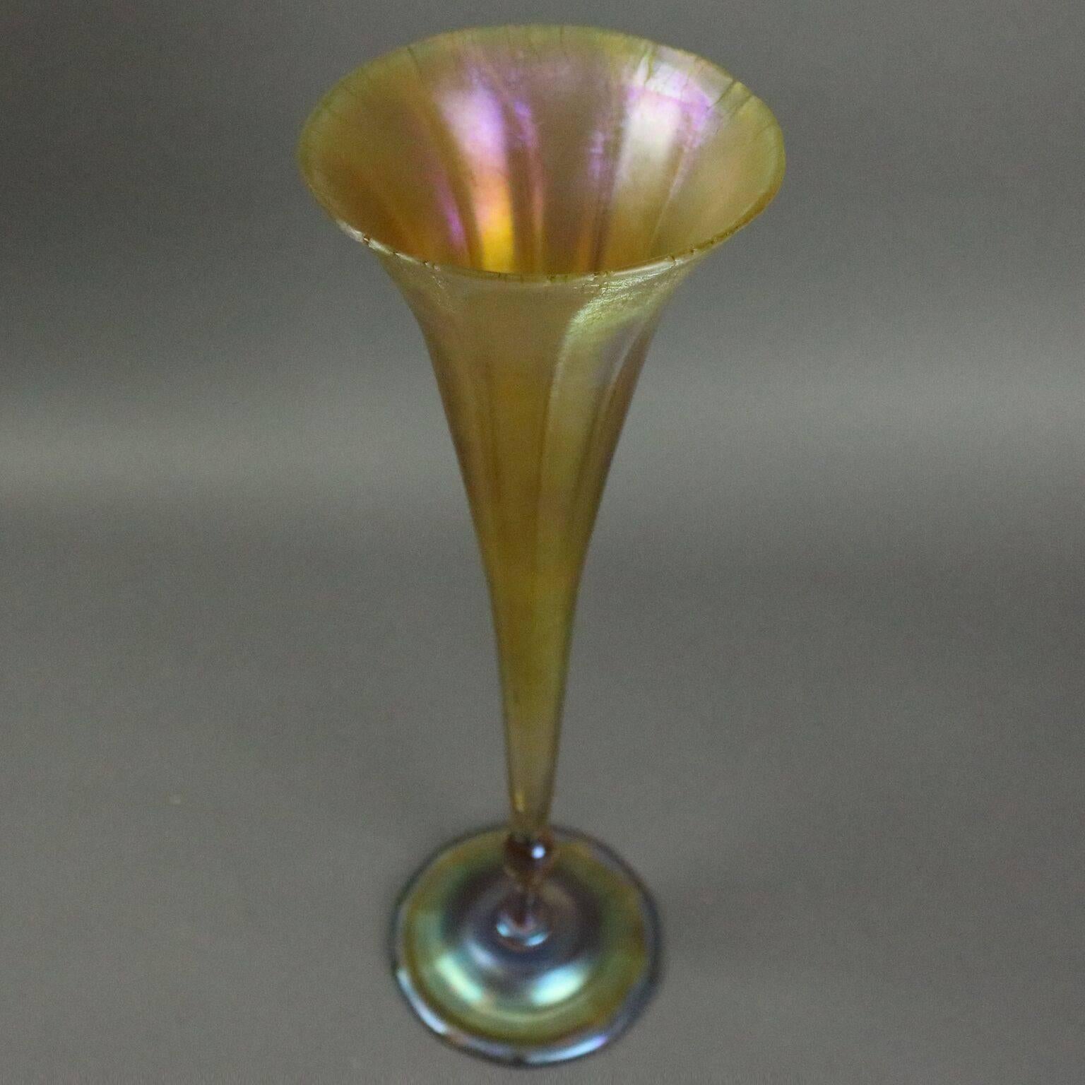 Antique Tiffany Favrille art glass trumpet vase features classic gold trumpet on irridized blue base, signed "L. C. Tiffany Favrille 1900" on base.

Measures - 15" H x 5.25" diam.