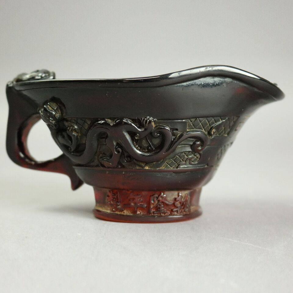 19th century antique Chinese hand-carved amber handled libation cup features Asian geckos about.

Measures: 3" H X 6" W X 3.5" D.