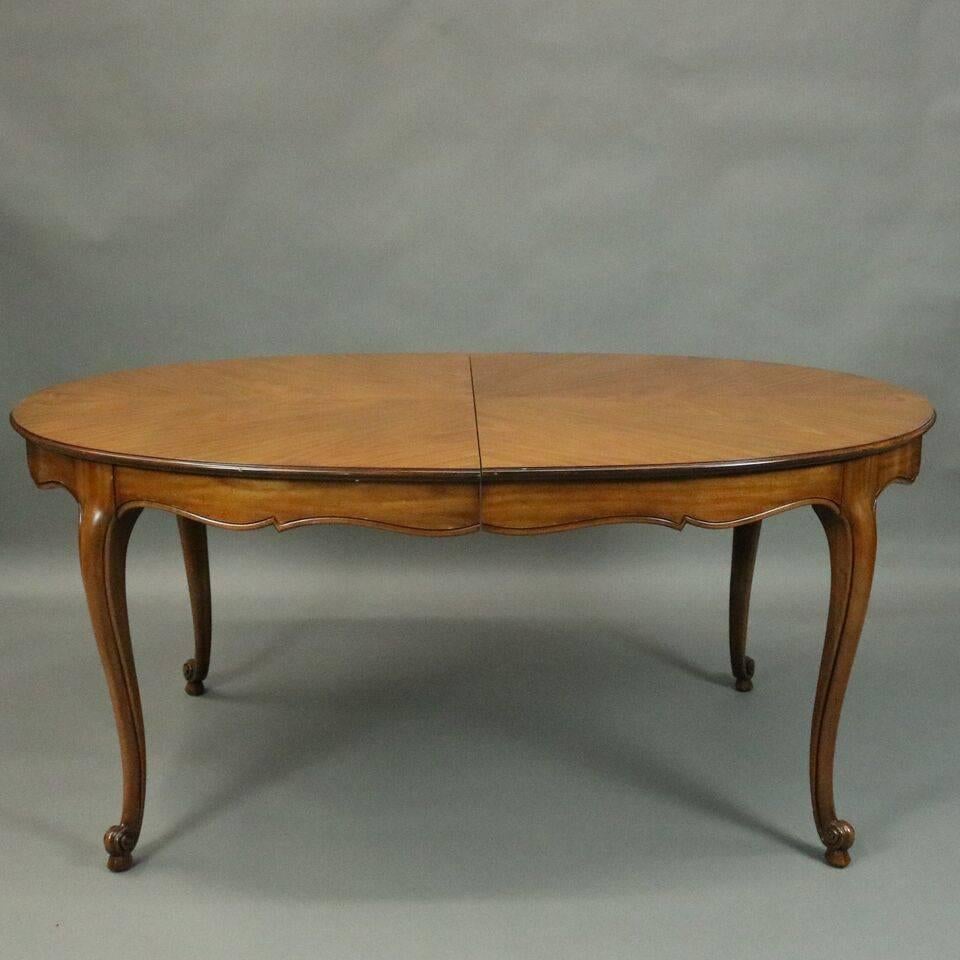 Vintage cherry French country Louis XV style dining table by Kindel Furniture Company, Borghese Collection, features sunburst style top, banded scalloped skirt and cabriole legs terminating in scrolled feet, three leaves, circa 1930.

Note -