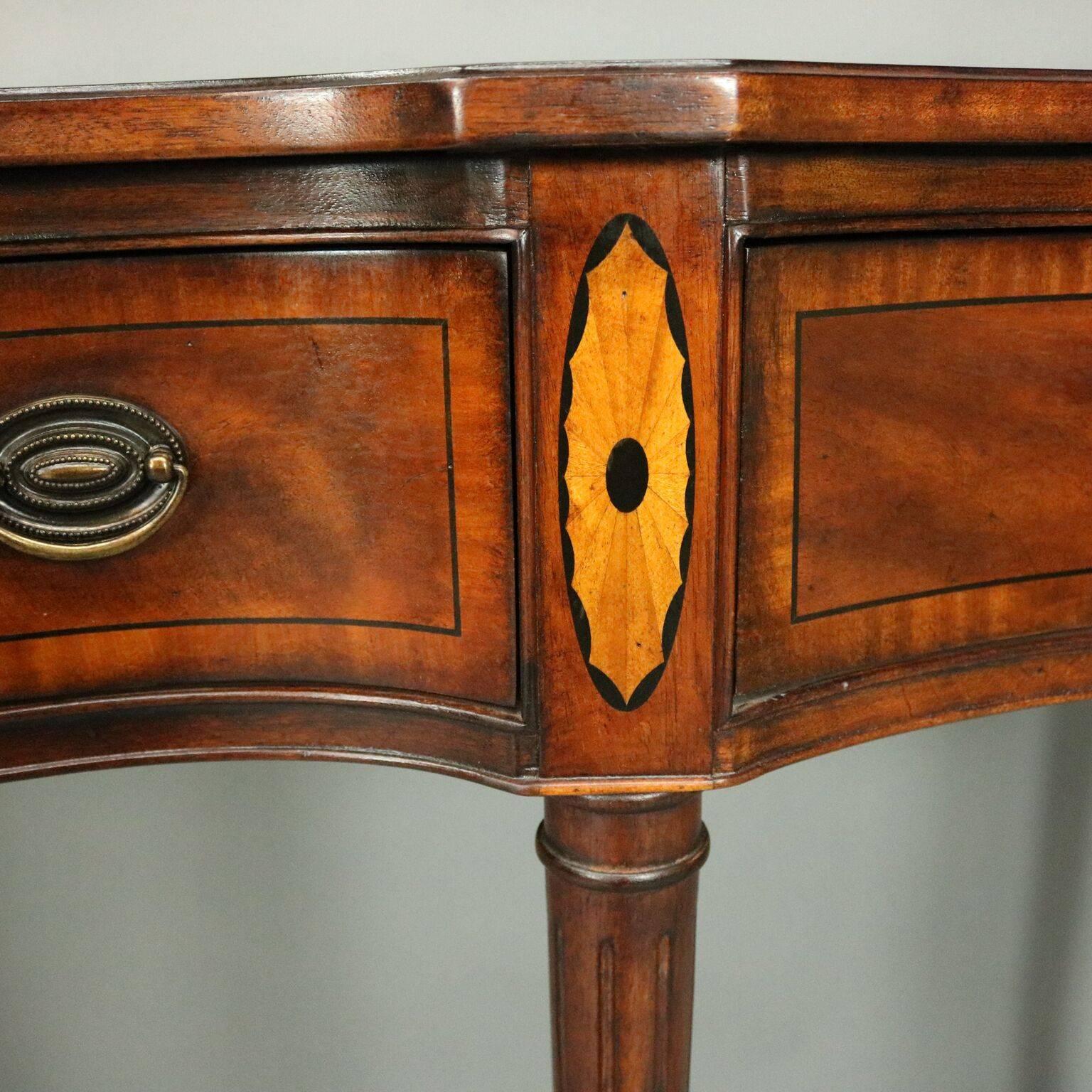 Vintage Drexel satinwood inlaid mahogany serpentine sideboard features three satinwood banded drawers, satinwood and ebonized inset, atop turned legs, brass Drexel plate inside drawer, circa 1950

Measures: 39.5" H x 71" W x 18" D.