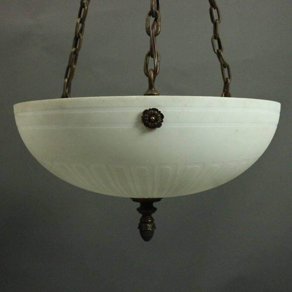 Antique Arts and Crafts hanging ceiling light features six lights nested in a Steuben acid etched calcite art glass dome with bronze accoutrements, circa 1910

Measures: 44