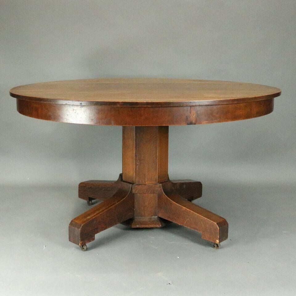 Antique Stickley Brothers mission oak round dining table features skirted round top above octagonal plinth, circa 1915.

Measures: 30" height x 53" diameter.
