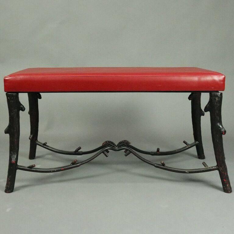 Vintage Adirondack Naturalistic style bench features wrought iron twig or branch form legs and stretchers supporting red vinyl cushion top, 20th century.

Measures: 20" H x 37.5" W x 17" D.