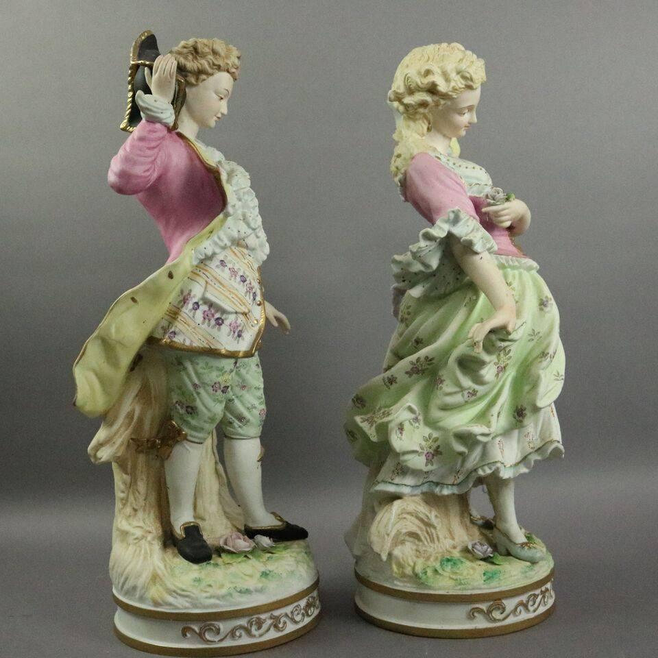 Pair of large antique hand-painted English porcelain figures of courting couple in traditional garb of Old England, hand numbered on bases, circa 1920.

Measure: 18.5" height x 7"diameter.