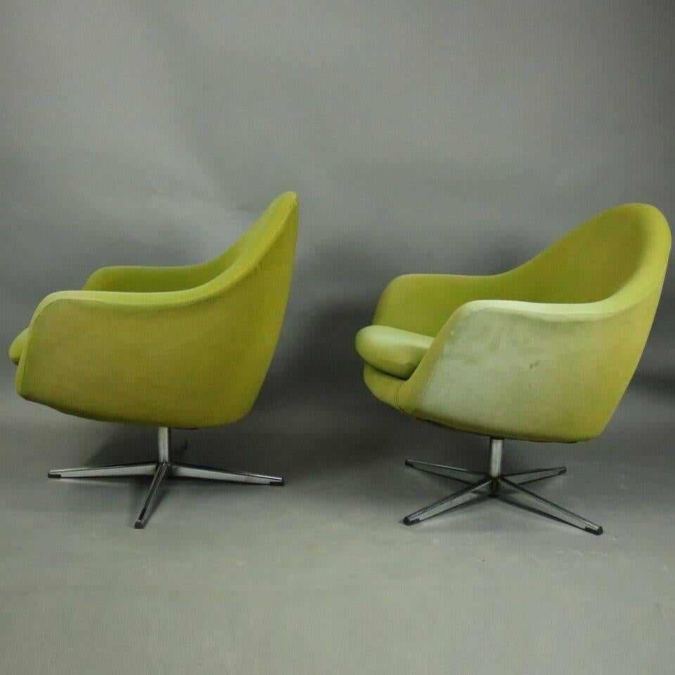Pair of Mid-Century Modern Knoll style swivel club chairs feature lime green upholstery and chrome base, circa 1960.

Measure: 31