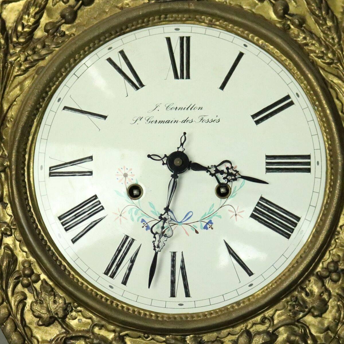 Antique French Rococo wag-on-wall clock features cast brass construction in urn and foliate decoration, enamel face with J. Cornillon, St. Germain-des-Fosses's, circa 1860.

Measures - 58" H X 13" W X 6.5" D.