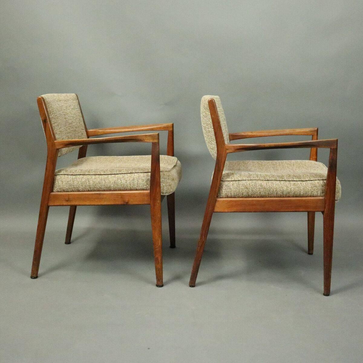 Pair of Mid-Century Danish modern armchairs feature teak construction, upholstered seat and back, original tag Edward Axel Roffman Associates, Inc., New York New York, Allentown Pennsylvania, numbered metal tag 4434, circa 1960.

Measures -
