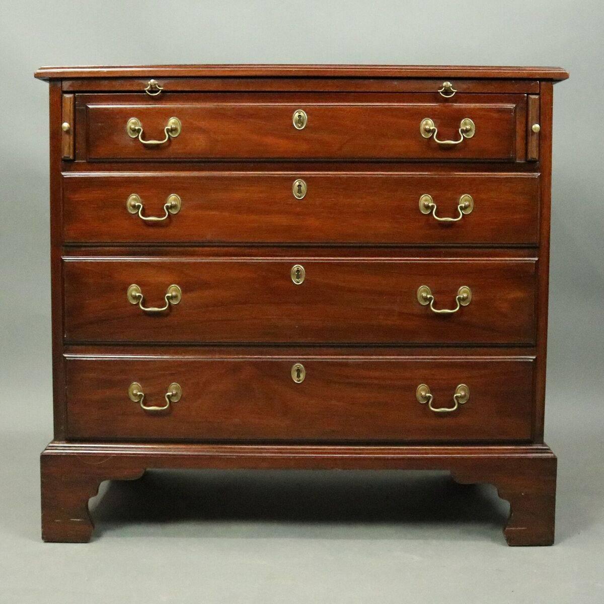 Antique silver chest features four drawers below pull-out surface, bronze pulls, side handles and blind escutcheons; branded/stamped on drawer interior "Virginia Galleries Furniture by Henkel-Harris Winchester, Virginia", circa