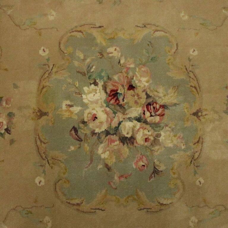 Vintage French Aubusson hand-knotted wool rug features flowers, reinceaux and scrollwork with central floral medallion with flanking floral sprays, circa 1950.

Measures - 110.75" x 59.5".