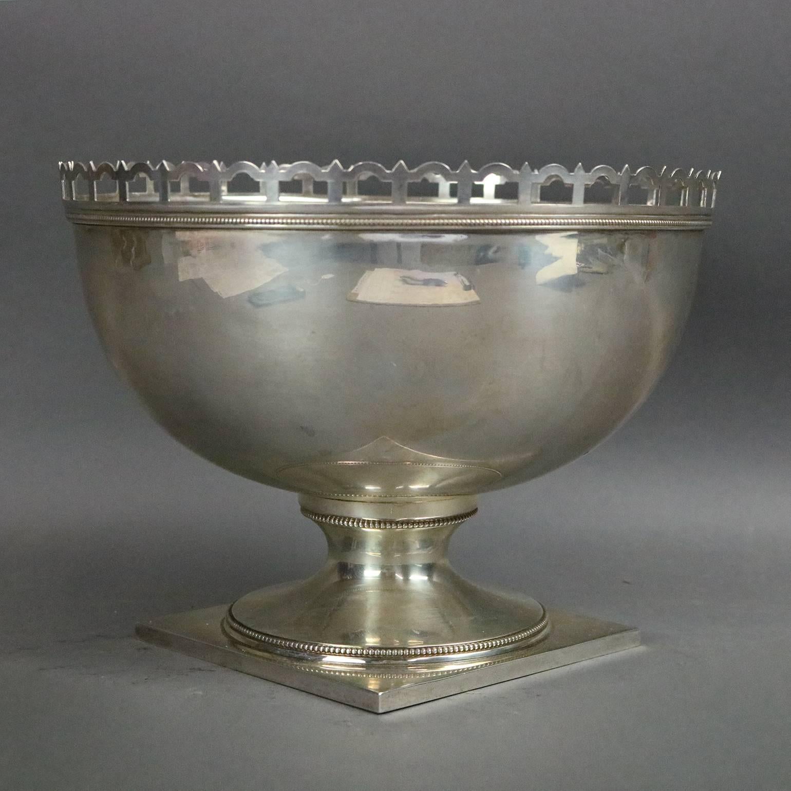 Antique sterling silver footed center bowl by J.E. Caldwell features pierced gallery rim and beaded edge decoration, 19th century.

Measures: 6.75" H x 8.75" diameter 5" x 5" base.