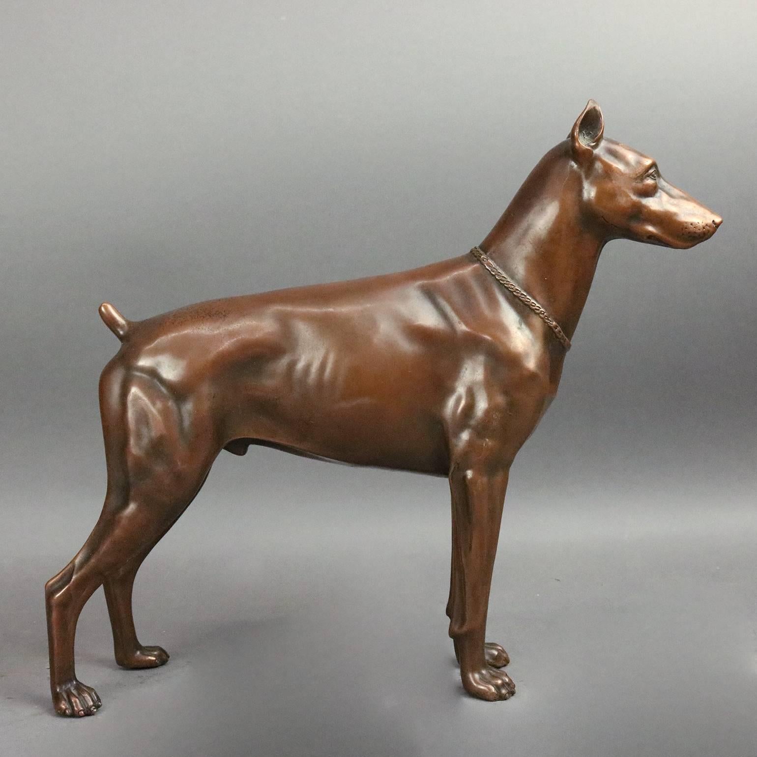 Antique bronzed cast metal statue dog, Doberman Pinscher, standing alert or on guard, hollow, circa 1900

Measures: 11" H x 12" W x 2.5" D.