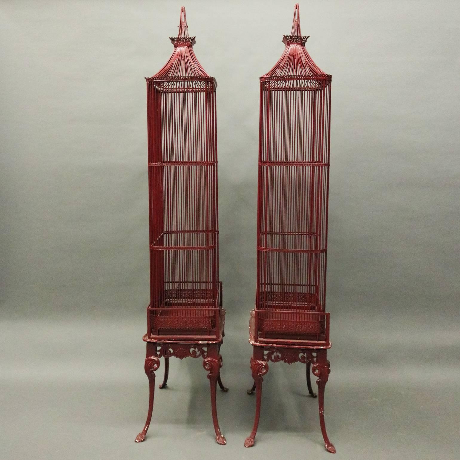 Pair of French Chinoiserie red painted cast metal display cabinets feature pagoda style bird cage design seated on shell and acanthus decorated cabriole legs each connected by pierced apron of scroll and acanthus, circa 1940

Measure - 83.5