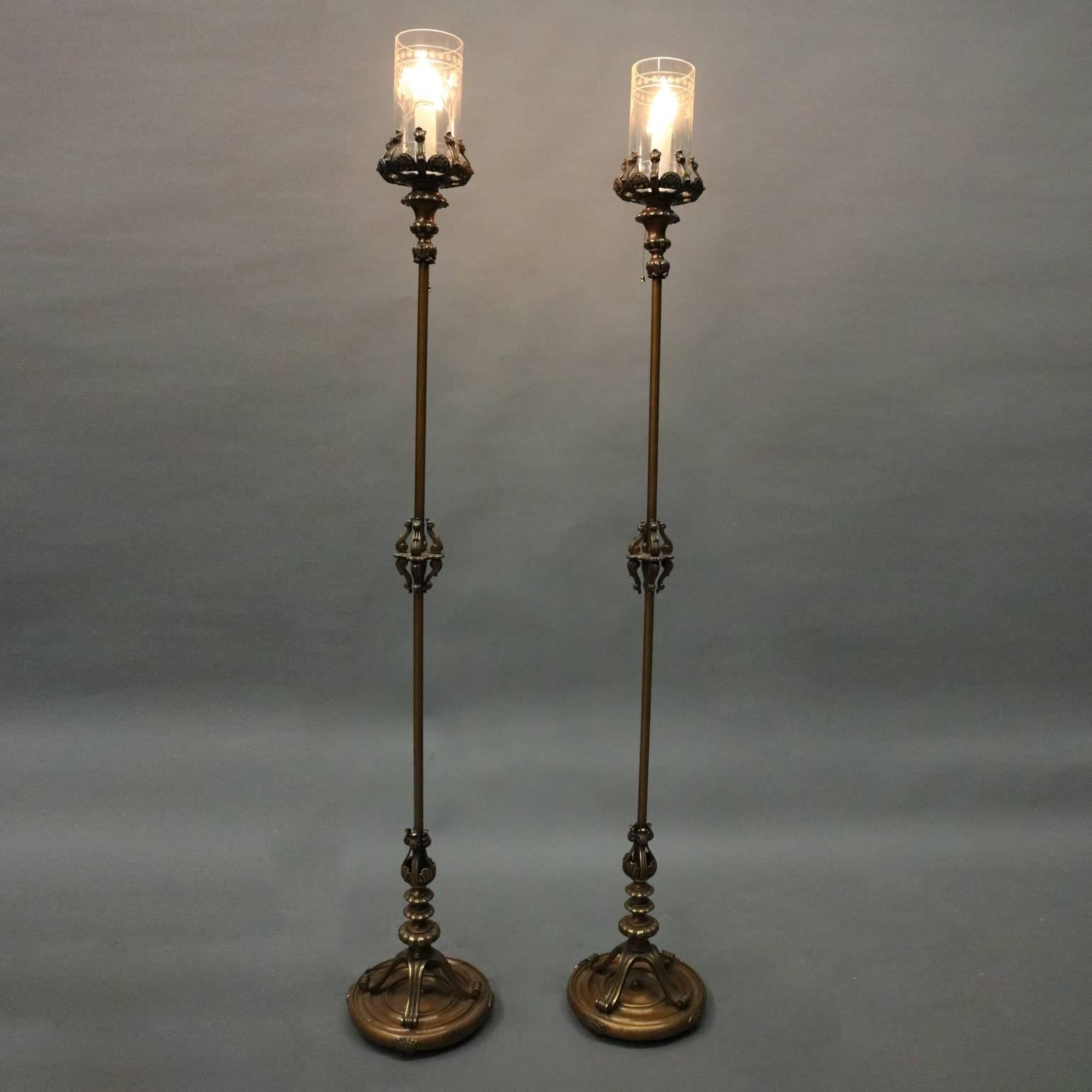 Pair of antique Handel style bronze torchiere floor lamps feature cast acanthus, scroll and egg-and-dart decoration, floral etched glass cylinder shades, newly re-wired, circa 1920

Measures: 63.5" H x 10" diam base, 3.75" diam