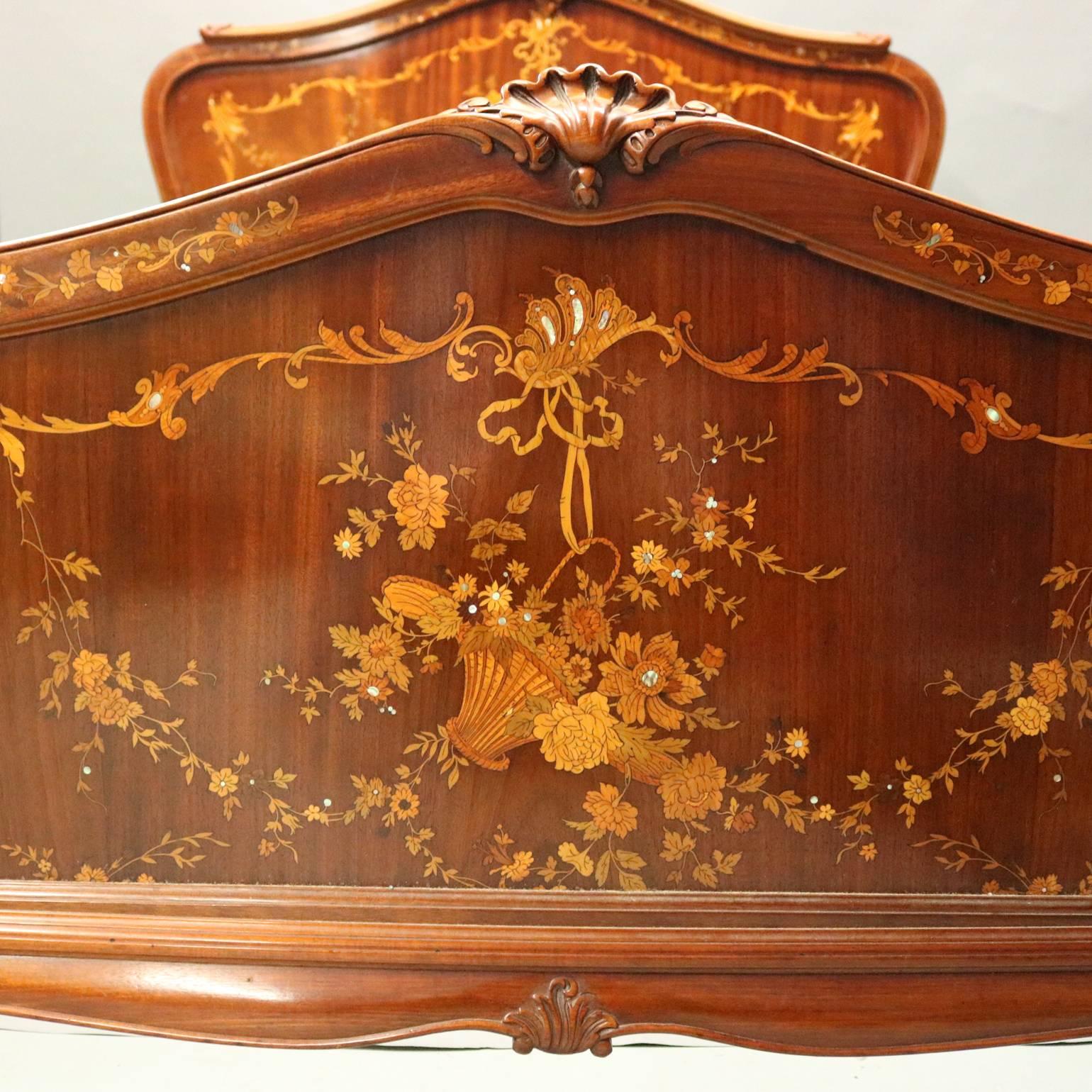 Antique R.J Horner & Co., New York, mahogany double bed with features headboard and footboard with satinwood floral and foliate marquetry and banding, mother-of-pearl inlay accents, carved graduated bellflowers, carved acanthus and stylized shell