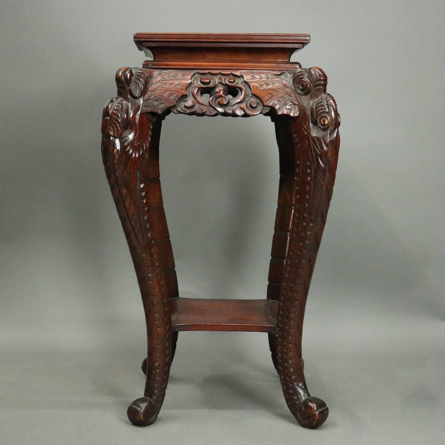 Vintage Chinese hardwood sculpture stand features heavily carved decoration including pierced apron, batwing, scroll, foliate and scale decoration, cabriole legs, incised top and lower shelf, circa 1950.

Measures - 30" H X 18" W X