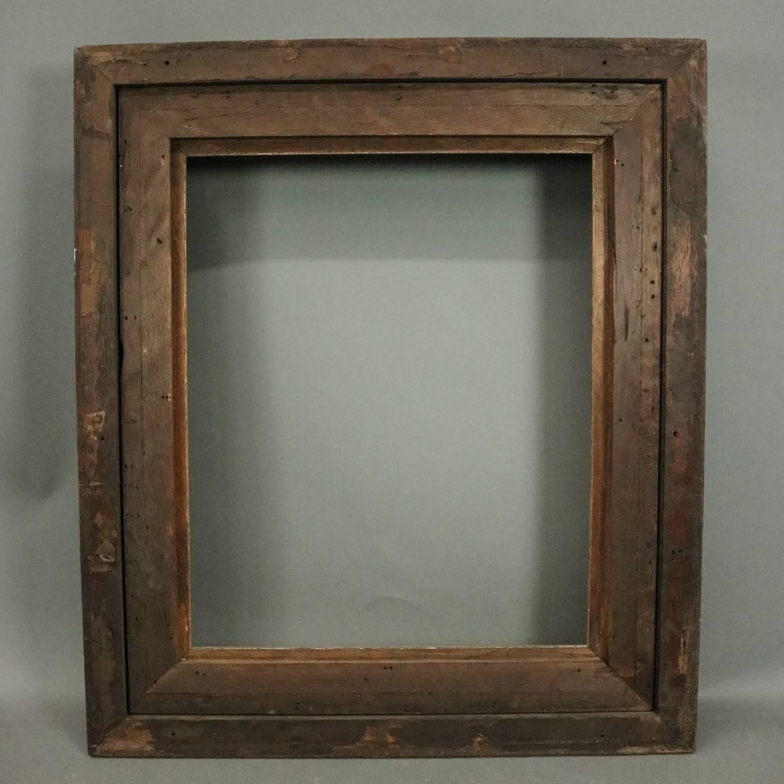Antique Eastlake walnut fine art frame features scroll and foliate incised decoration, giltwood interior, and ebonized die joints, scallops and edging, circa 1890.

Measures: 33