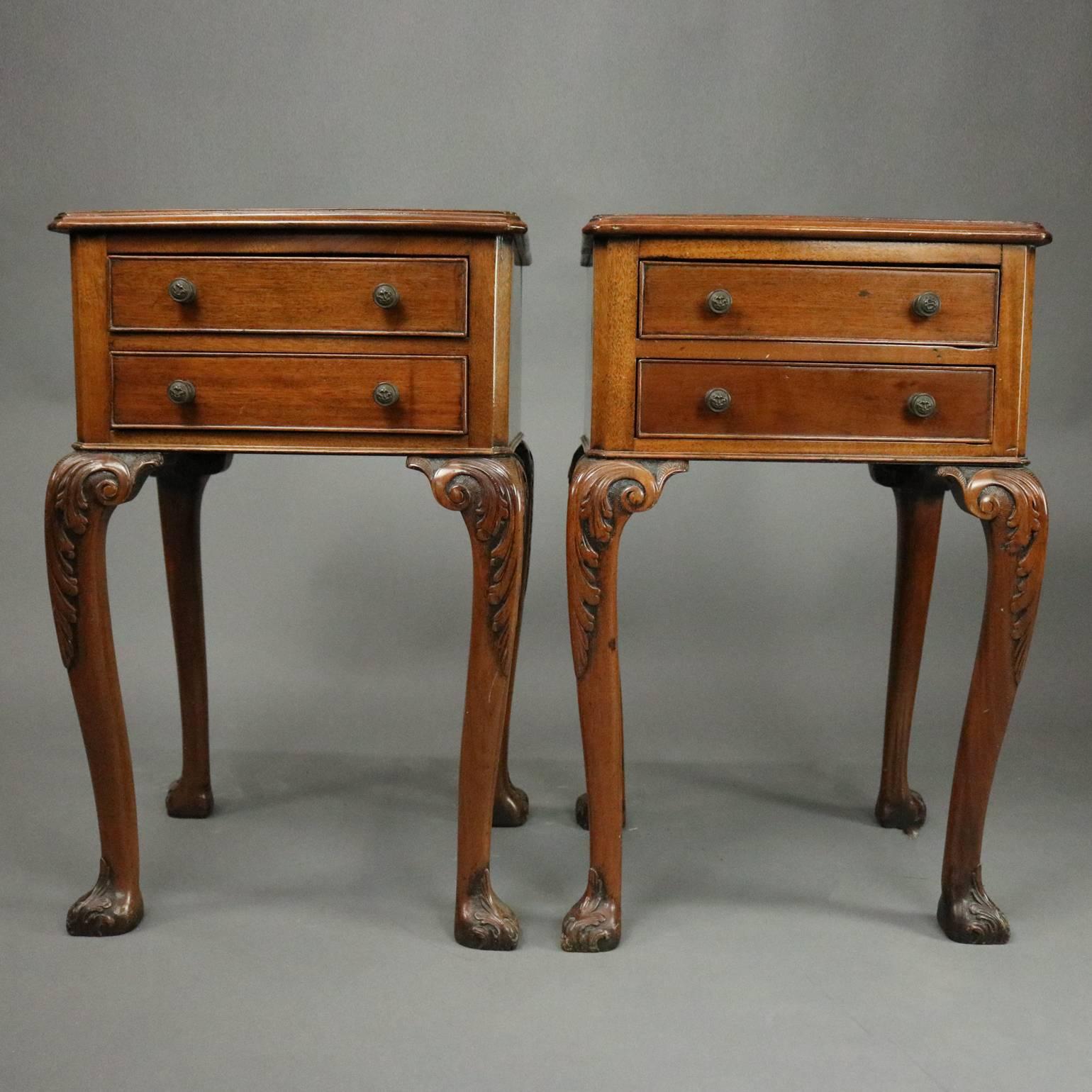 Pair of antique English Regency two-drawer end tables feature mahogany construction with two-drawers, cabriole legs with carved acanthus knees and feet, cast bronze lion head hardware, circa 1820.

Measure: 25" H x 15" W x 14" D.