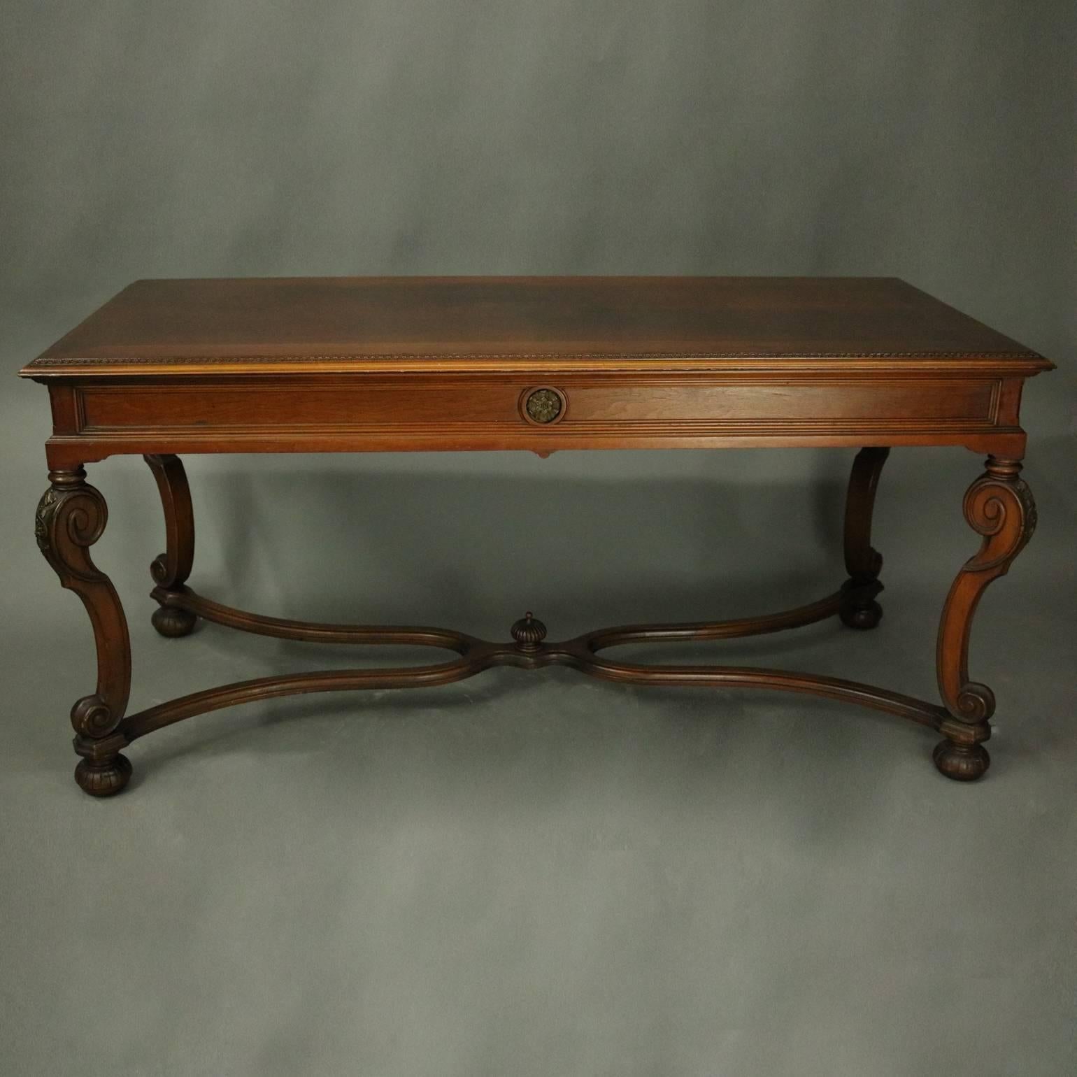 Antique French Louis XIV style sofa table features top with carved foliate border surround of bookmatched quarters and burl inset, reeded apron with central caved rosettes, supporting scrolled volute legs with carved acanthus knees, connecting
