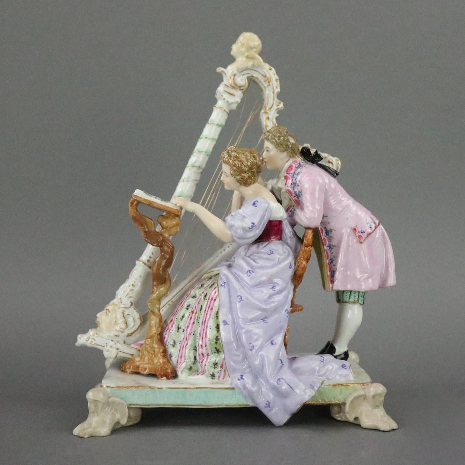 Antique German Ludwigsburg hand-painted and gilt porcelain figural group of harpist and assistant reviewing sheet music together, maker mark on base, three stags horns Arms of Wurtembere in blue, circa 1820

Measures: 7.5" H x 7" W x
