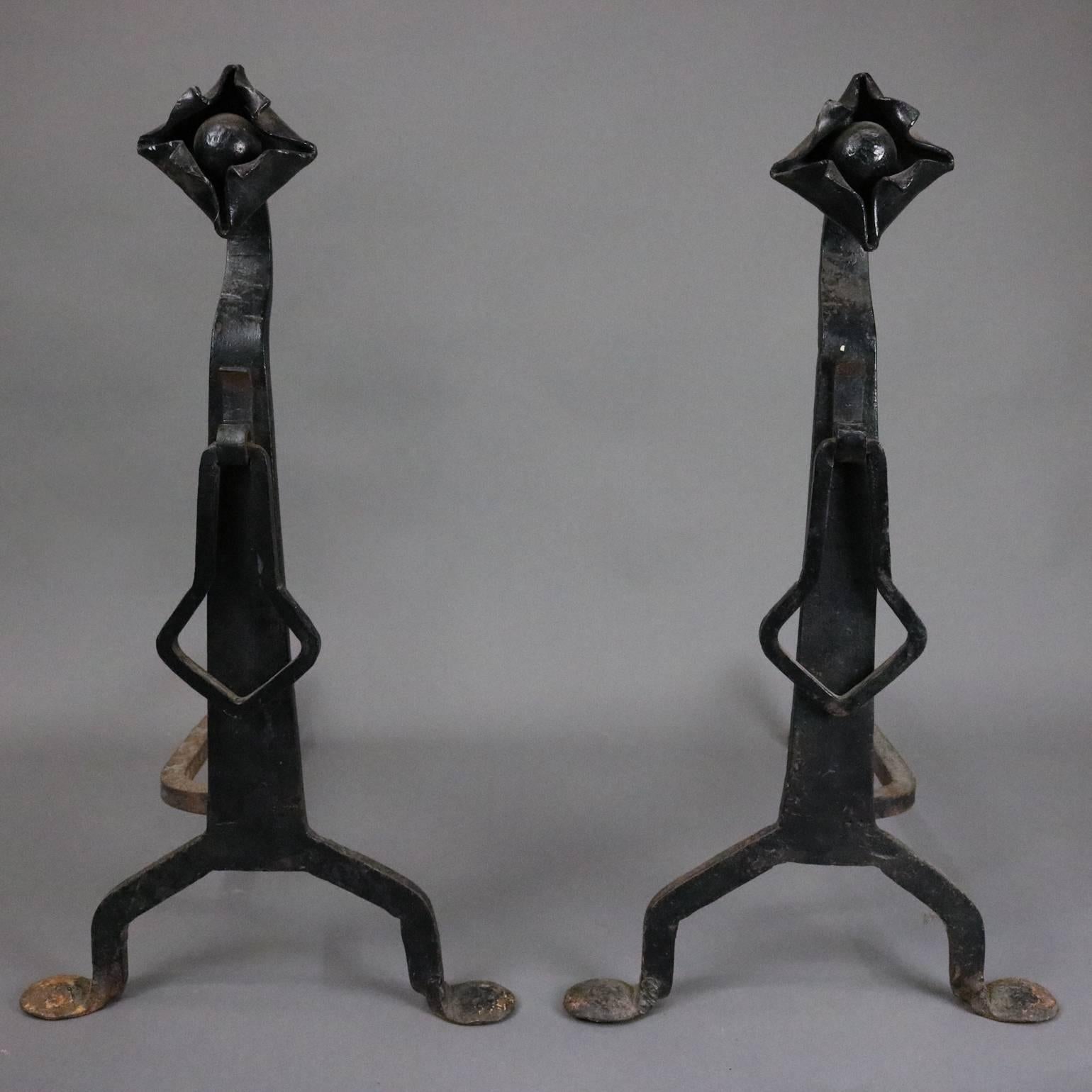 Pair of antique Yellin School Arts & Crafts wrought iron fire place andirons feature stylized flower finial, shaft ring, and are seated on splayed legs, circa 1910

***DELIVERY NOTICE – Due to COVID-19 we are employing NO-CONTACT PRACTICES in the