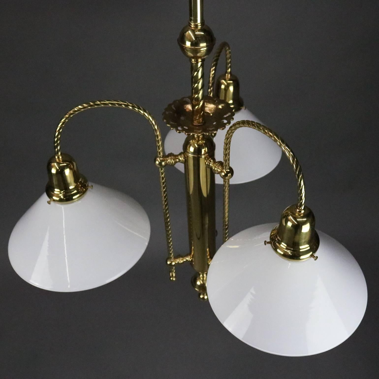Vintage French hanging light fixture features three twisted rope arms terminating in opaque conical shades, 20th century

Additional identical fixture listed separately*

Measures - 36.5" drop x 27"diam, 2"diam fitter.