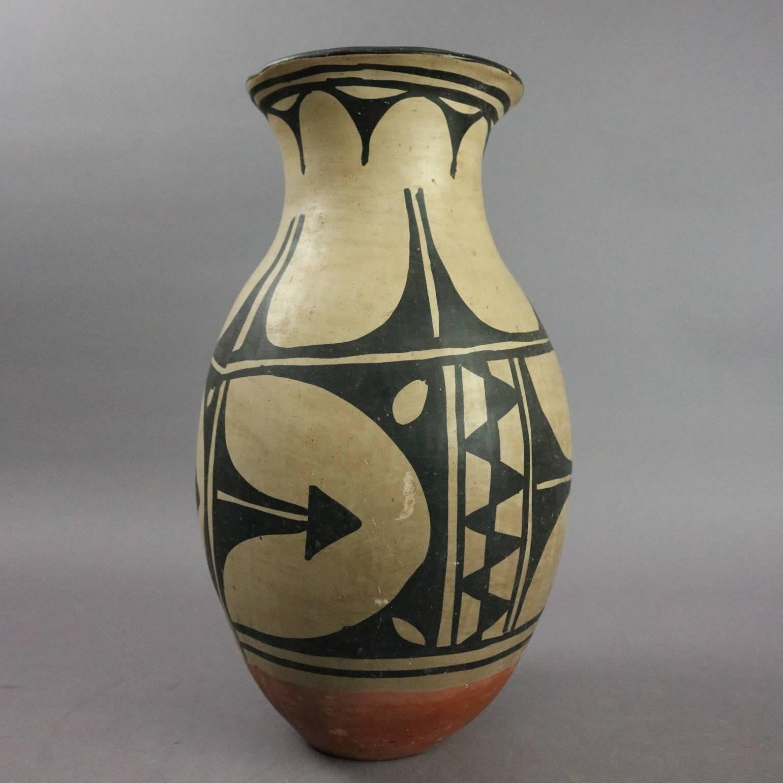 Antique Native American Indian Acoma hand thrown clay jar hand-painted with slip glaze features stylized botanical and geometric elements, circa 1900

Measures: 13.5