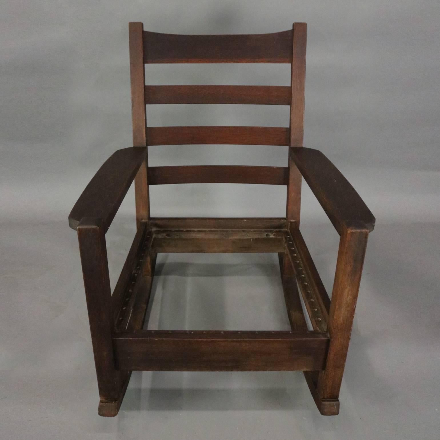 Antique early Arts and Crafts signed Gustav Stickley oversized rocking chair features Mission oak slat-back frame, circa 1910

Measures: 39