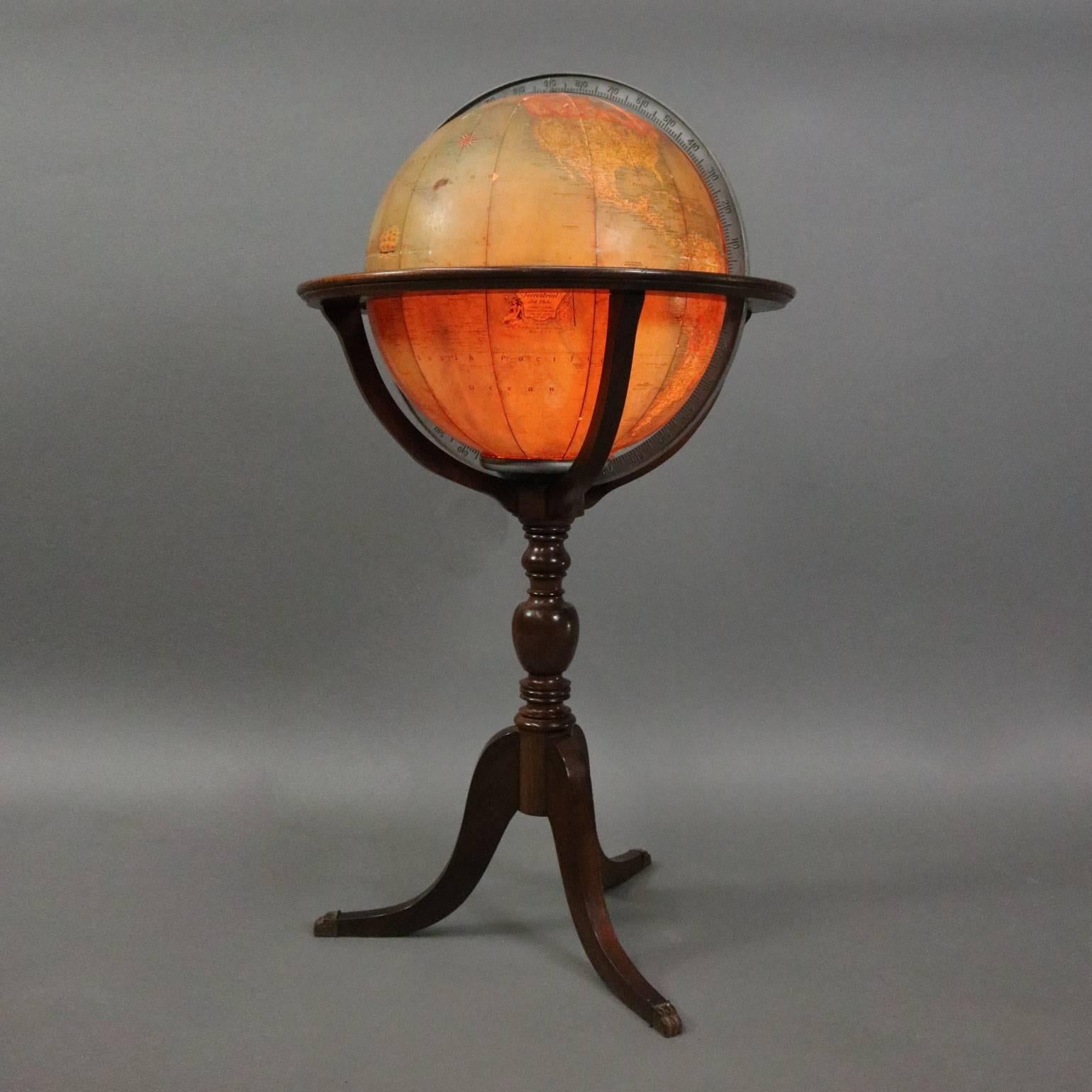 Vintage lighted library world globe on mahogany tripod floor stand, circa 1930.

Measures: 40" H x 20" diam.