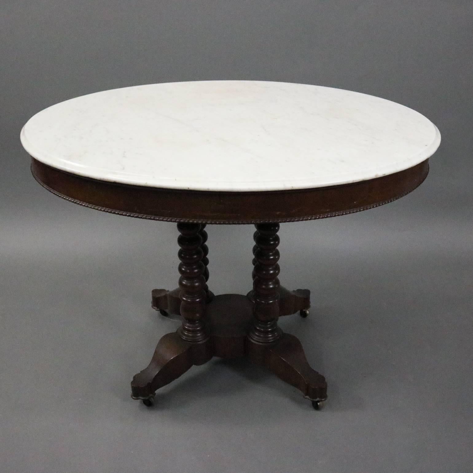 Antique parlor lamp table features oval marble top seated on carved walnut base with four ball turned legs, circa 1880

Measures: 29" H X 40" W X 32" D.