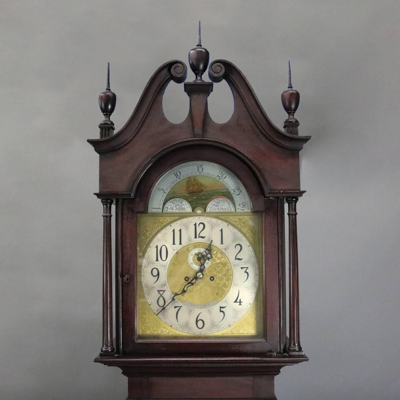 Antique Herschede tall case clock features cherry case with finial flanked broken arch pediment, moon phase dial decorated with tall mast ship and signed S. Kind & Sons Philadelphia, works signed Herschede, clock in working condition, circa