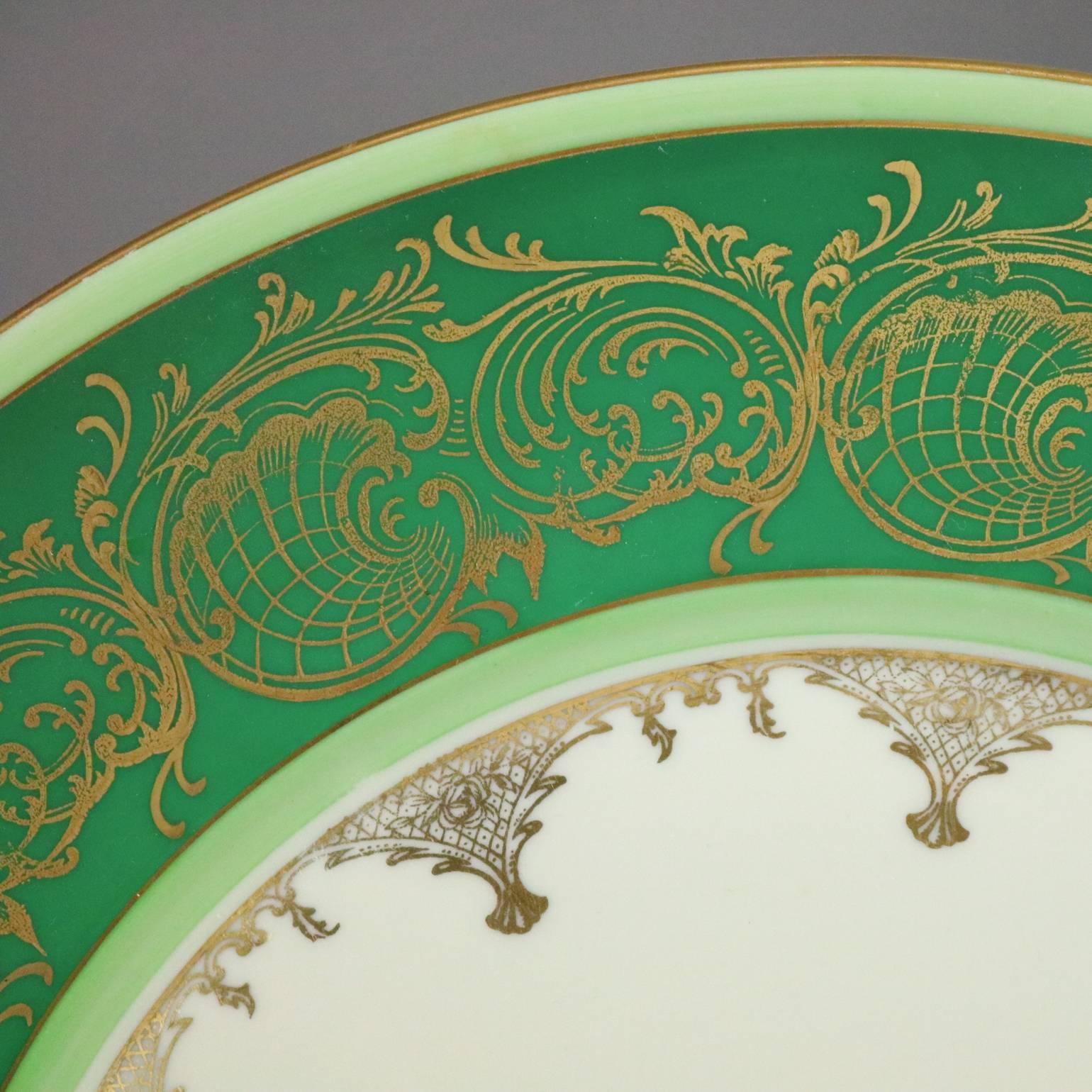 Set of eight antique Bavarian dinner plates feature emerald green border with gold gilt scrolled rinceaux decoration, en verso green shield maker mark "Schwarzenhammer, Germany", circa 1890

Measure: 11" D.