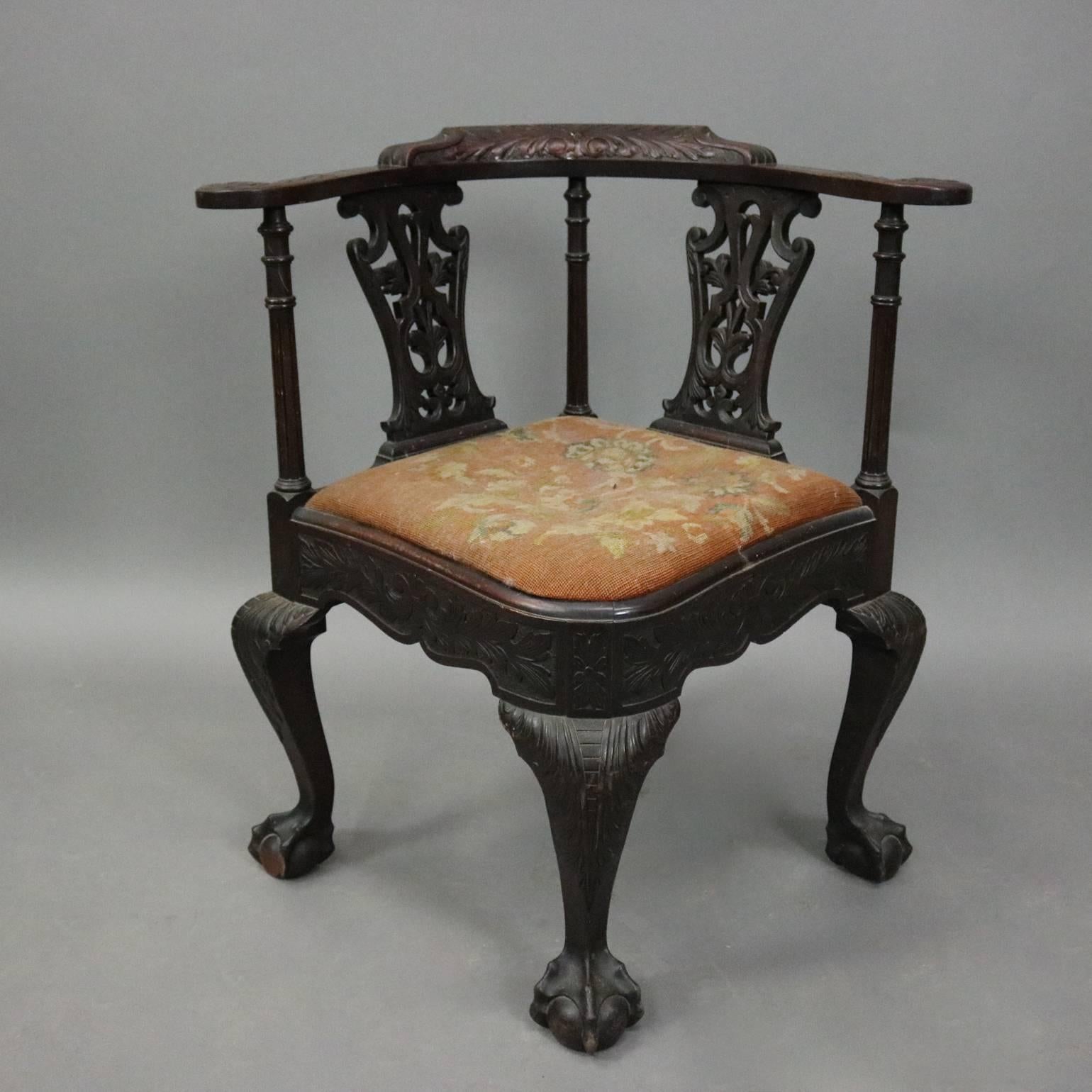 Antique Chippendale style corner chair features foliate carved frame with claw and ball feet and pierced back, needlepoint upholstered seat, circa 1880

Measures: 31" H x 29" W x 25" D, 19" seat height.