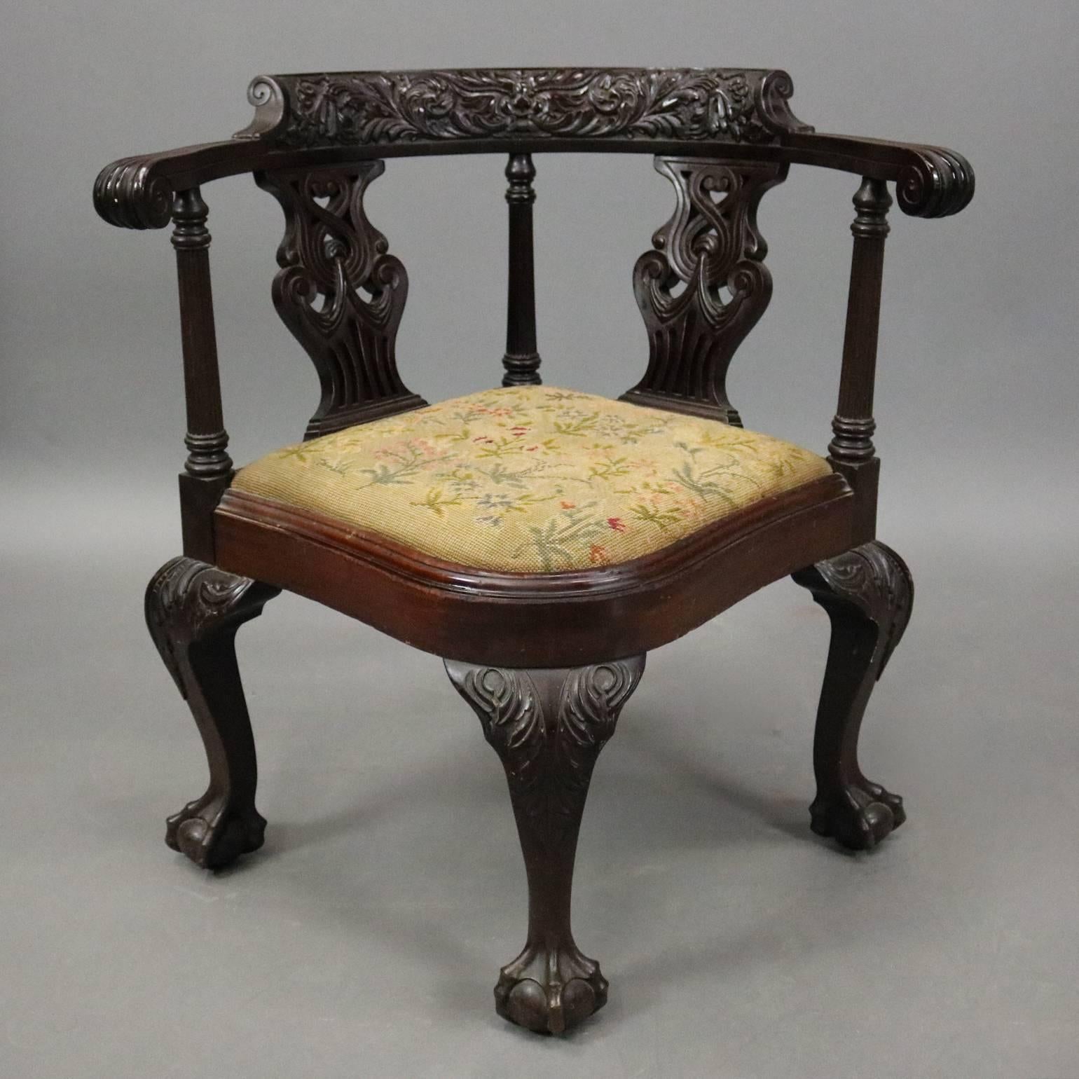 Antique Chippendale style corner chair features foliate carved frame with claw and ball feet and pierced back, needlepoint upholstered seat, circa 1880

Measures: 30.5" H x 29" W x 23.5" D, 17" seat height.