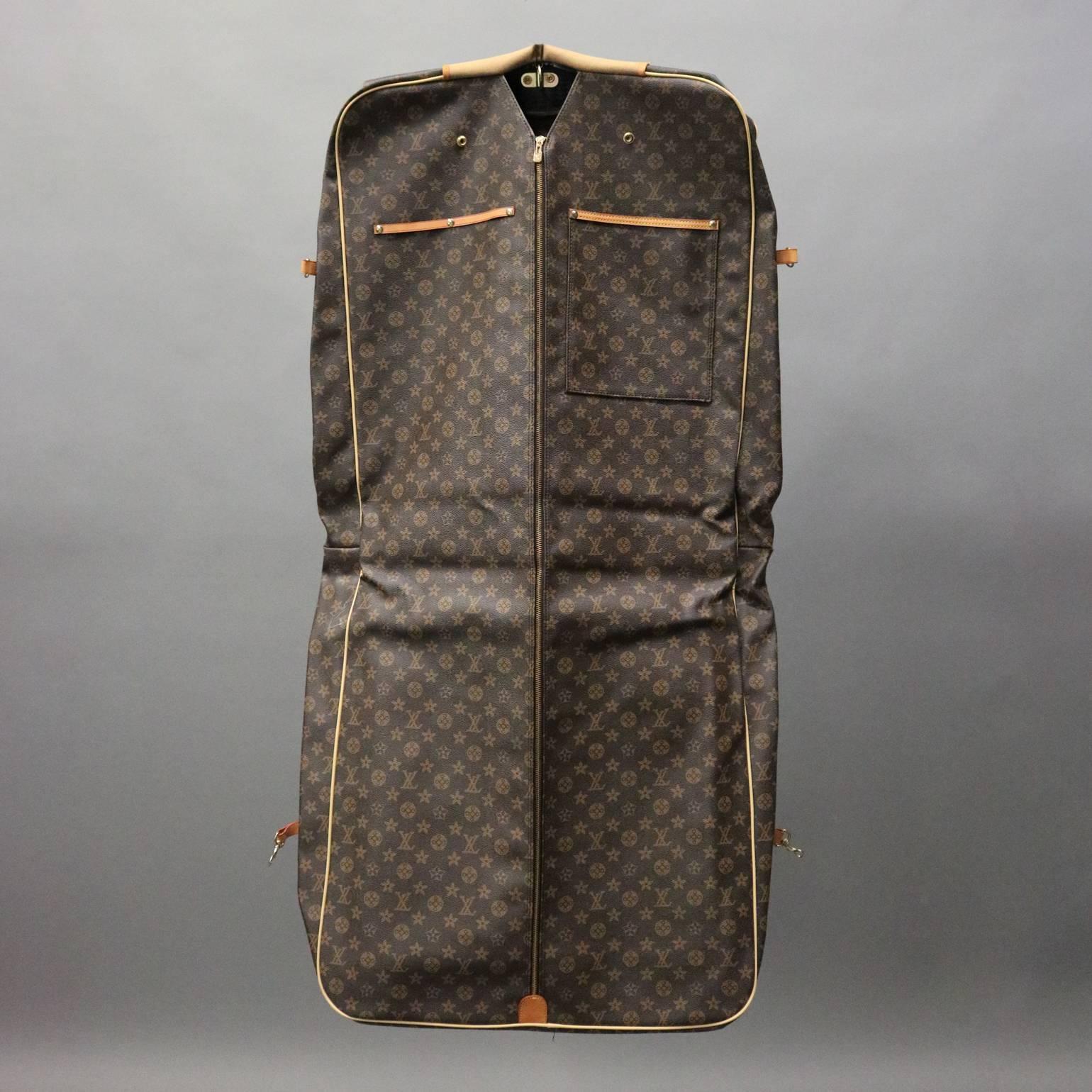 Vintage Louis Vuitton style traveling bag features quality construction with main garment compartment and additional zippered storage pouches, reminiscent of the authentic Louis Vuitton monogram canvas Portable Bandouliere Garment Bag, circa