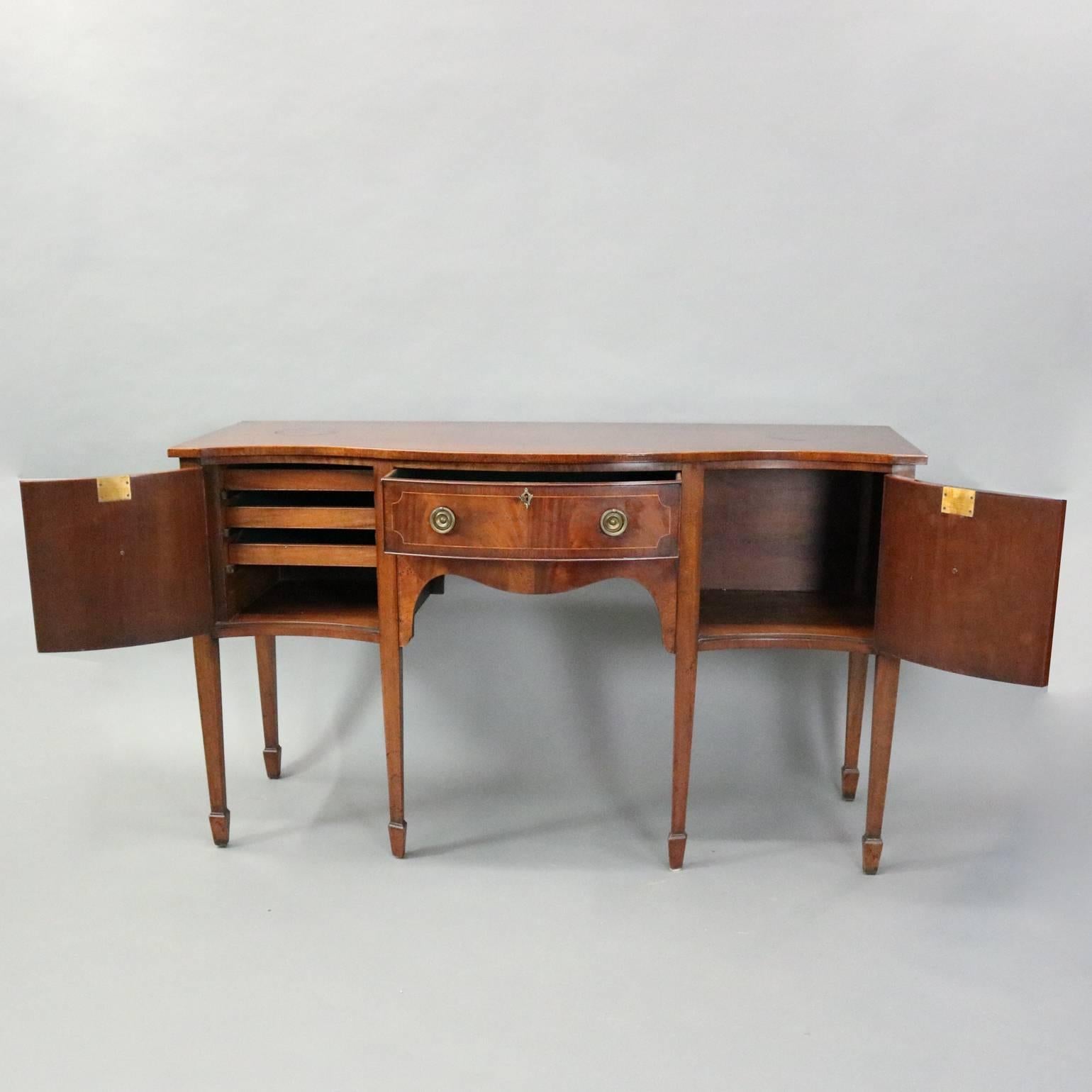 Vintage Federal style mahogany sideboard features serpentine front with satinwood banding, bronze pulls, circa 1930

Measures: 35.5" H x 59.5" W x 22.25" D.