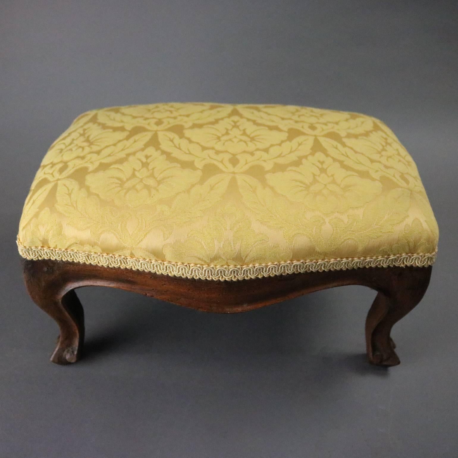 Antique French Louis XV style footstool features carved walnut base with scrolled cabriole legs with upholstered upper, circa 1880

Measures: 7.5" Hx 14.5" W x 11" D.