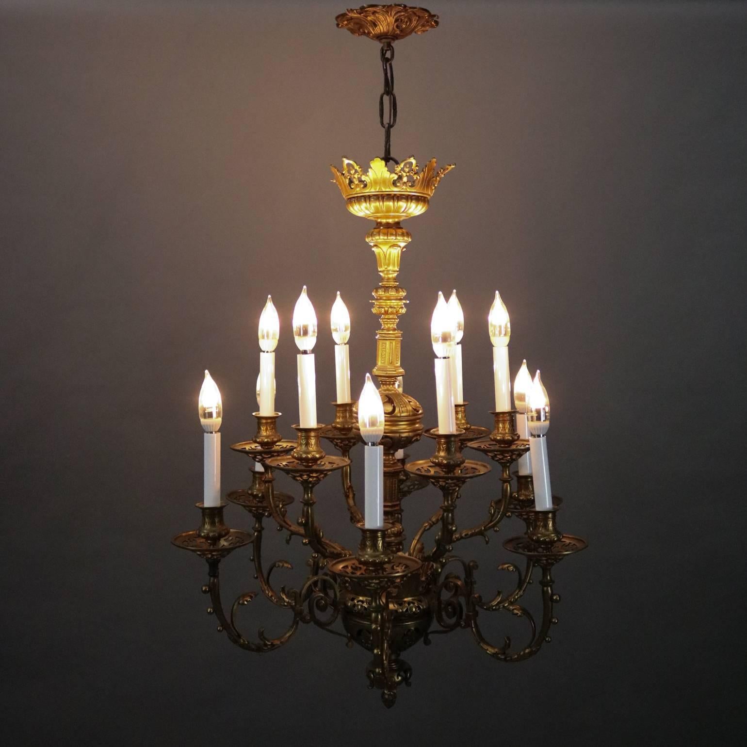 Vintage French Louis XV cast bronze chandelier features pierced foliate body supporting eleven scroll and foliate arms terminating in pierced bobeches supporting candle style lights, canopy reminiscent of royal crown, newly re-wired, circa