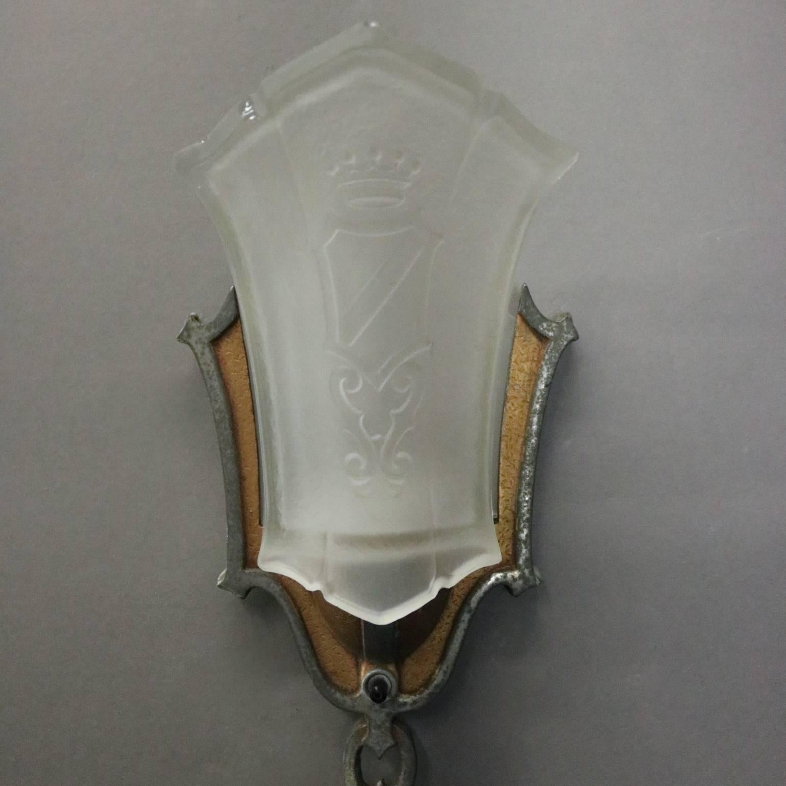 Pair of antique Art Deco slip shade sconces feature bi-colored metal frame housing frosted shade with crown and shield motif, newly re-wired, circa 1920

Matching chandelier listed separately

Measures: 11" H x 5" W x 4" D.