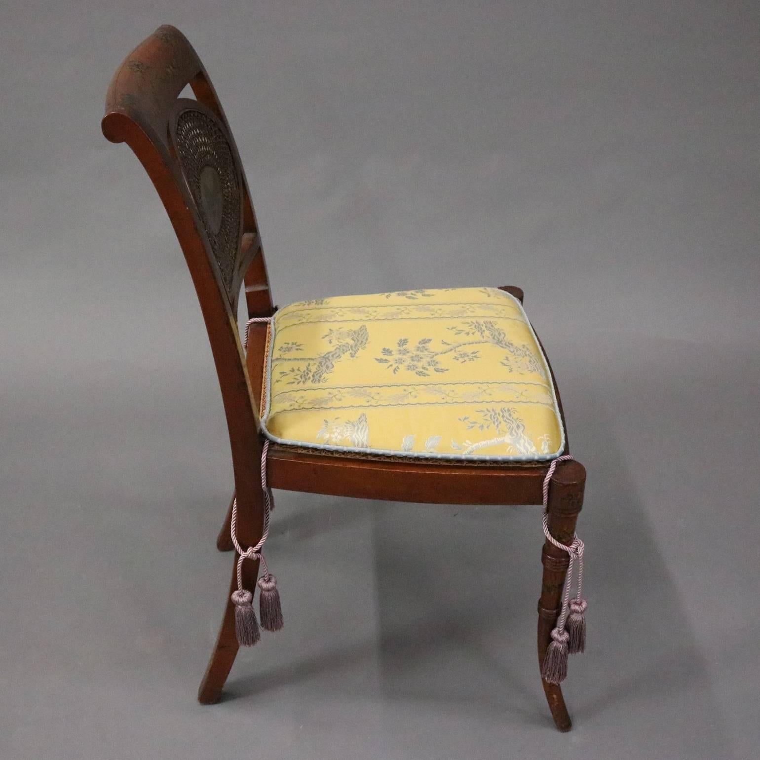 Antique English Regency side chair features mahogany frame with hand-painted floral decoration, caned seat and back with central medallion of landscape 
river scene, circa 1890

Measures: 33.5" H x 19" W x 16" D, 17" seat