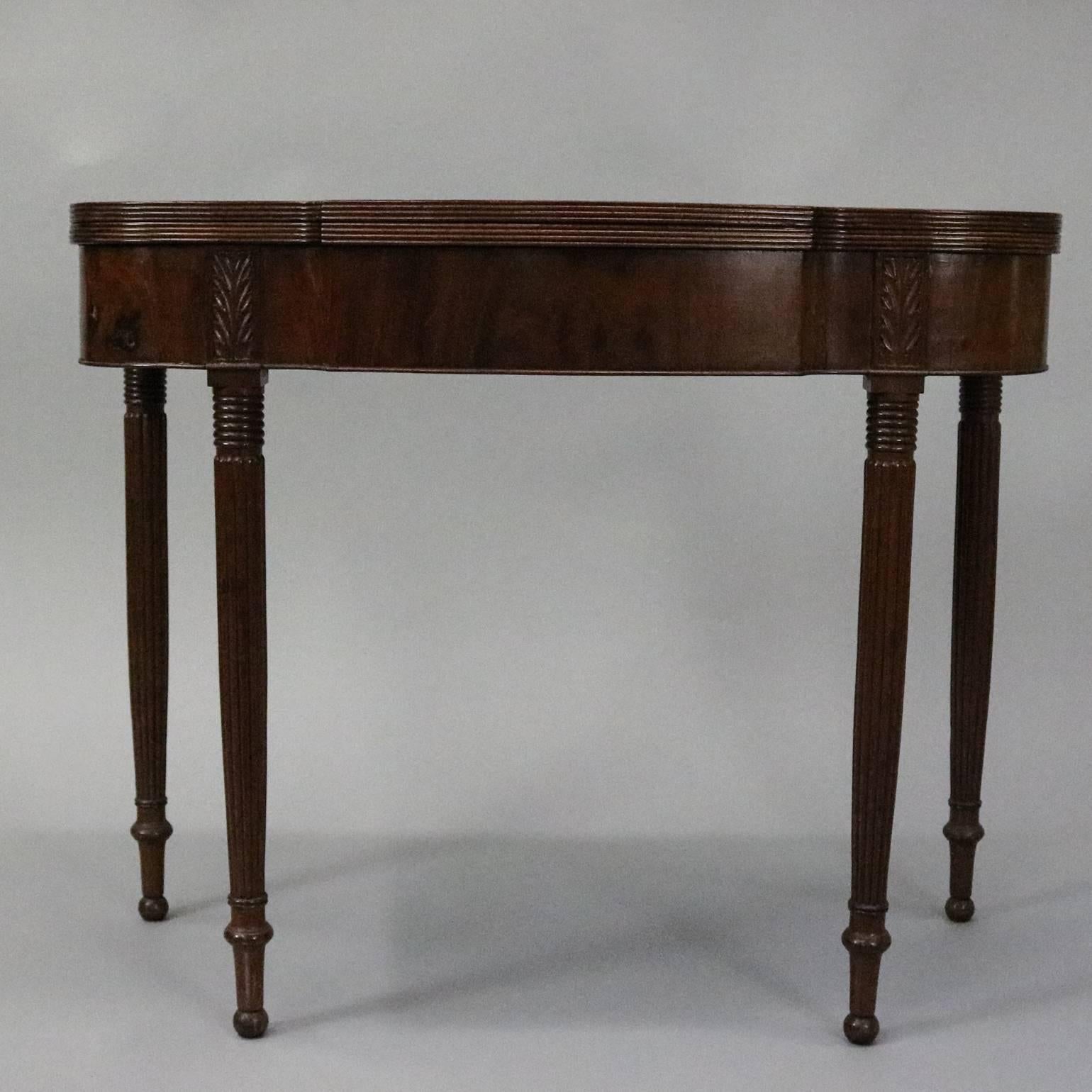 Antique Sheraton mahogany game table features reeded legs beneath carved acanthus die joints, scalloped top, circa 1830


Measures: 29