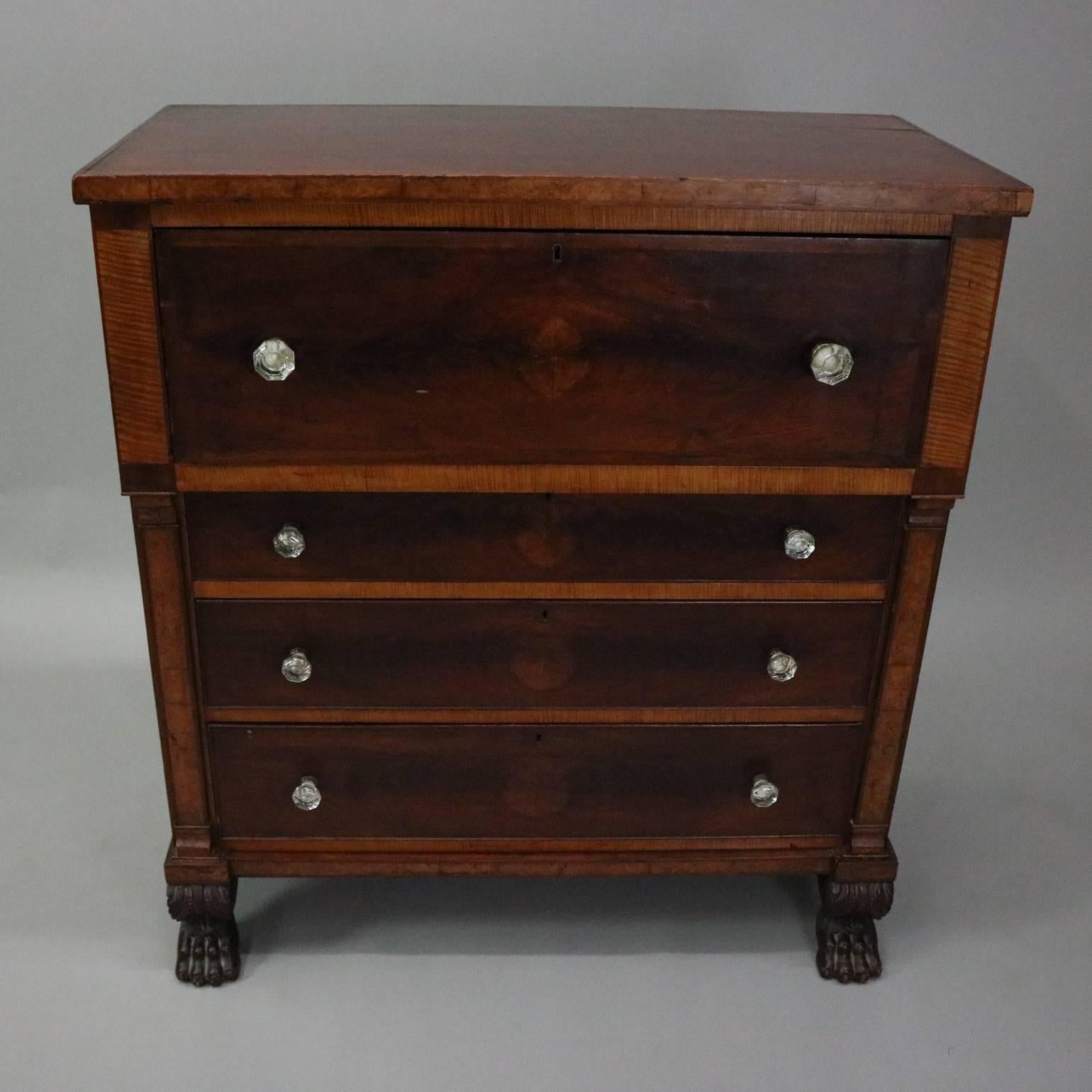 Antique American Empire flame mahogany butler's chest features bookmatched flame mahogany drawers with tiger maple and burl facing, front drops to reveal writing surface and interior storage compartments with drawers, central compartment with inlaid
