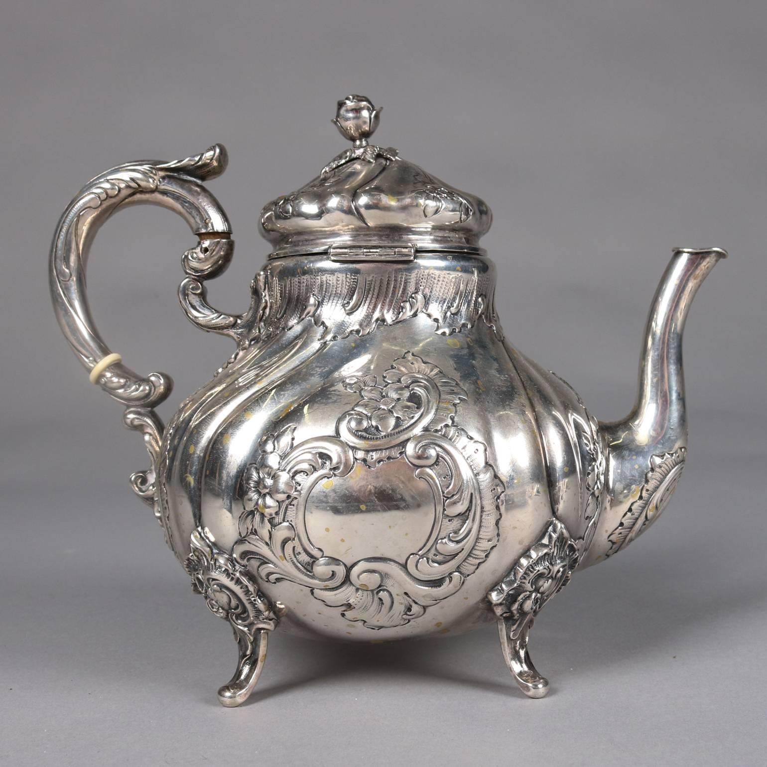 Antique .800 silver footed teapot, gadroon and foliate decorated with rose finial, marked .800, 19th century.

Measures: 8" H x 9" W x 6" D.