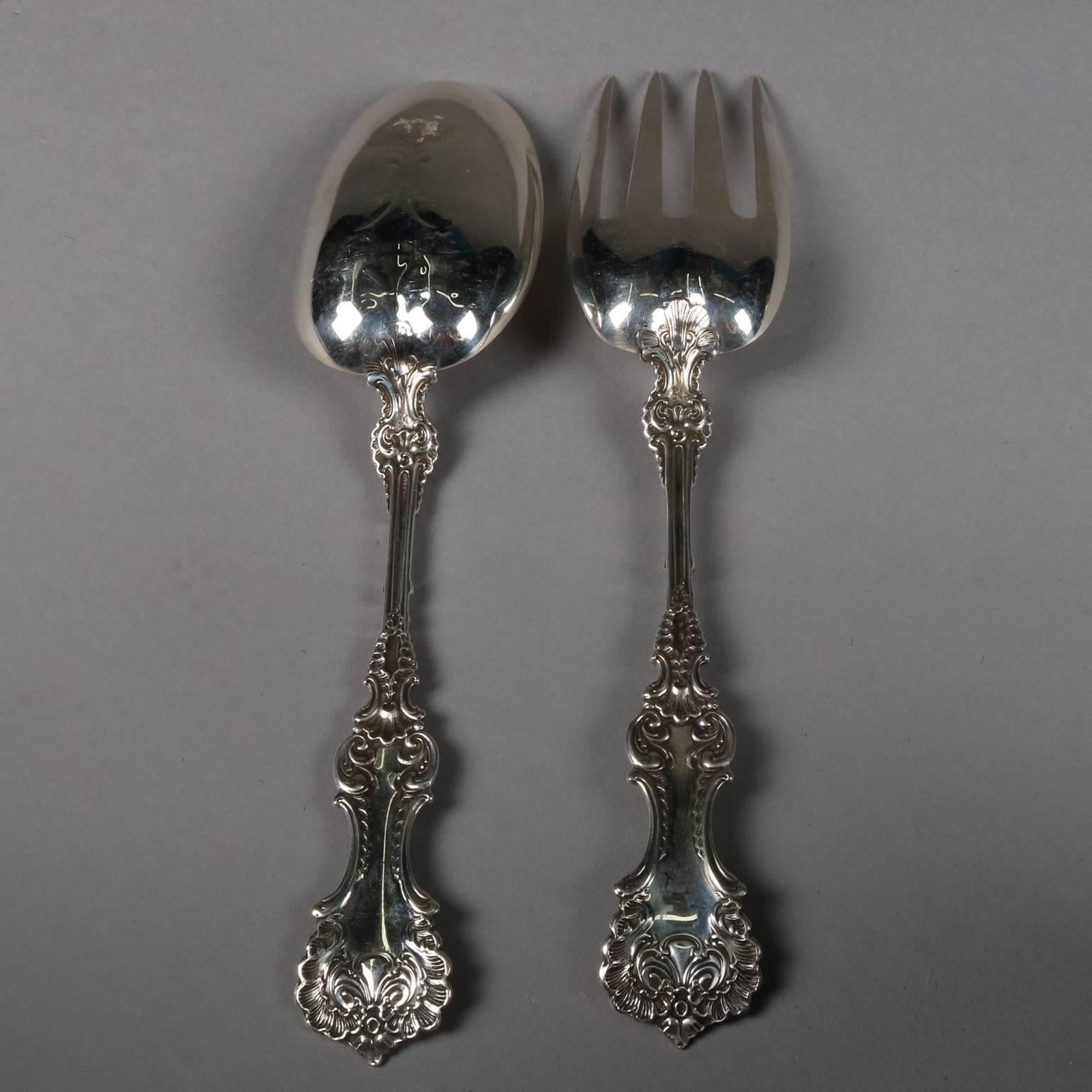Antique sterling silver serving set includes fork and spoon, scroll and foliate design, marked Sterling

Measure: 9" x 2".