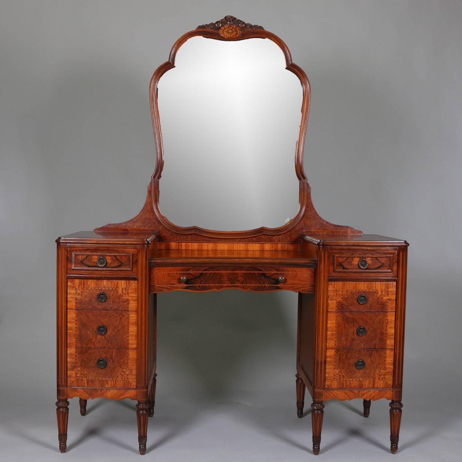 Antique mirrored dressing table features bookmatched flame mahogany and burl panels with deeply striated and inlaid parquetry bordering, carved foliate and floral accents, circa 1920

Matching high chest and low chest listed separately.