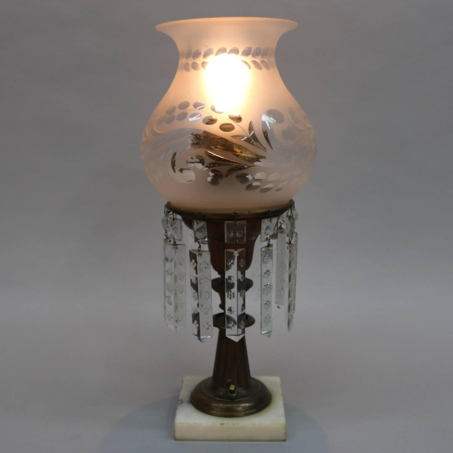 Antique brass electrified solar table lamp features gilt bronze base, floral decorated cut crystal prisms, etched shade, and THE ARCTIC MB CO. N.Y. single wick burner, 19th century

Measures: 17