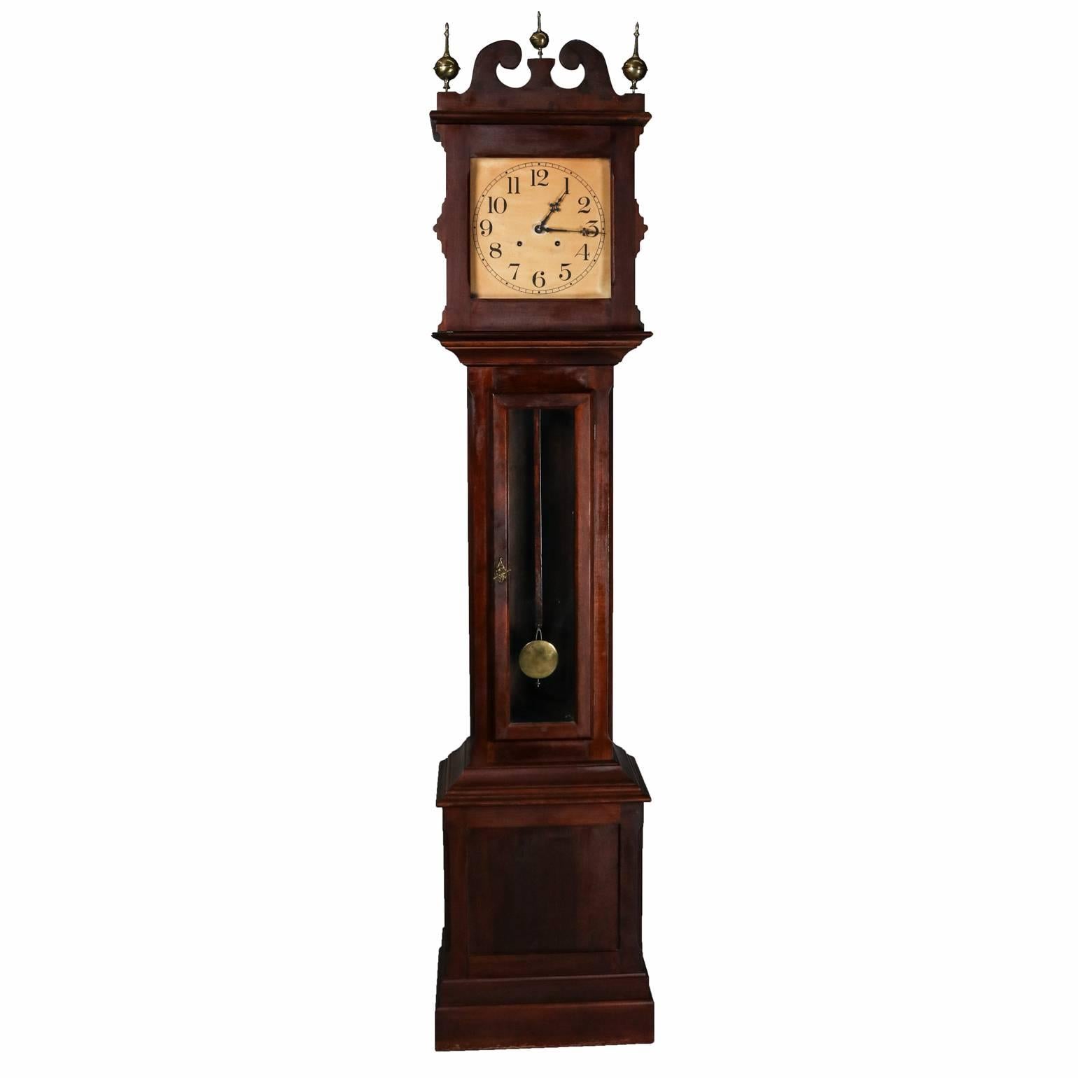 Antique mahogany Ithaca Clock Co. grandfather tall case clock features broken arch pediment and bronze spherical finials, newspaper article enclosed, with key, circa 1890

Measures: 88" H x 18" W x 11" D.